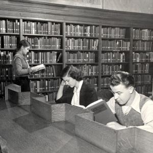 Black and white photograph of students reading in the library, approximately 1940.