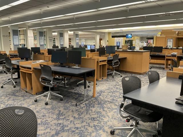 Group of computers and tables and desks